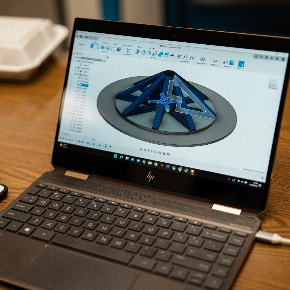 An image of a laptop opened to display a design of a drone landing platform.